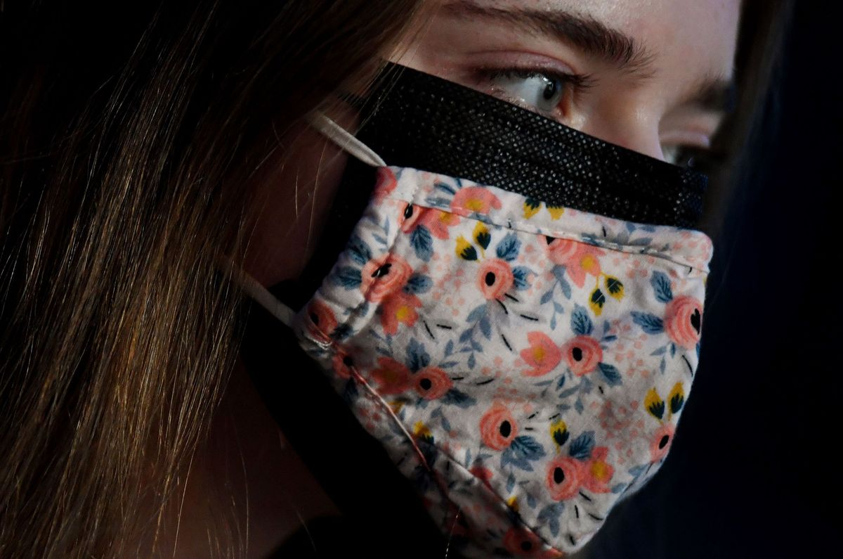 A woman wearing a cloth mask over a surgical mask in Arlington, Virginia, on February 8, 2021.