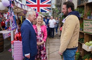 The Prince of Wales talks to James Bye while Kellie Bright smiles beside him