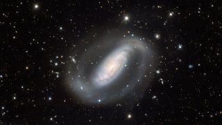 an oval-shaped galaxy with big, wispy arms against a background of stars