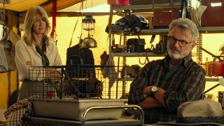 Laura Dern and Sam Neill talk in a tent over a locust in Jurassic World Dominion.