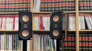 Monitor Audio Studio 89 standmount speakers in front of book case