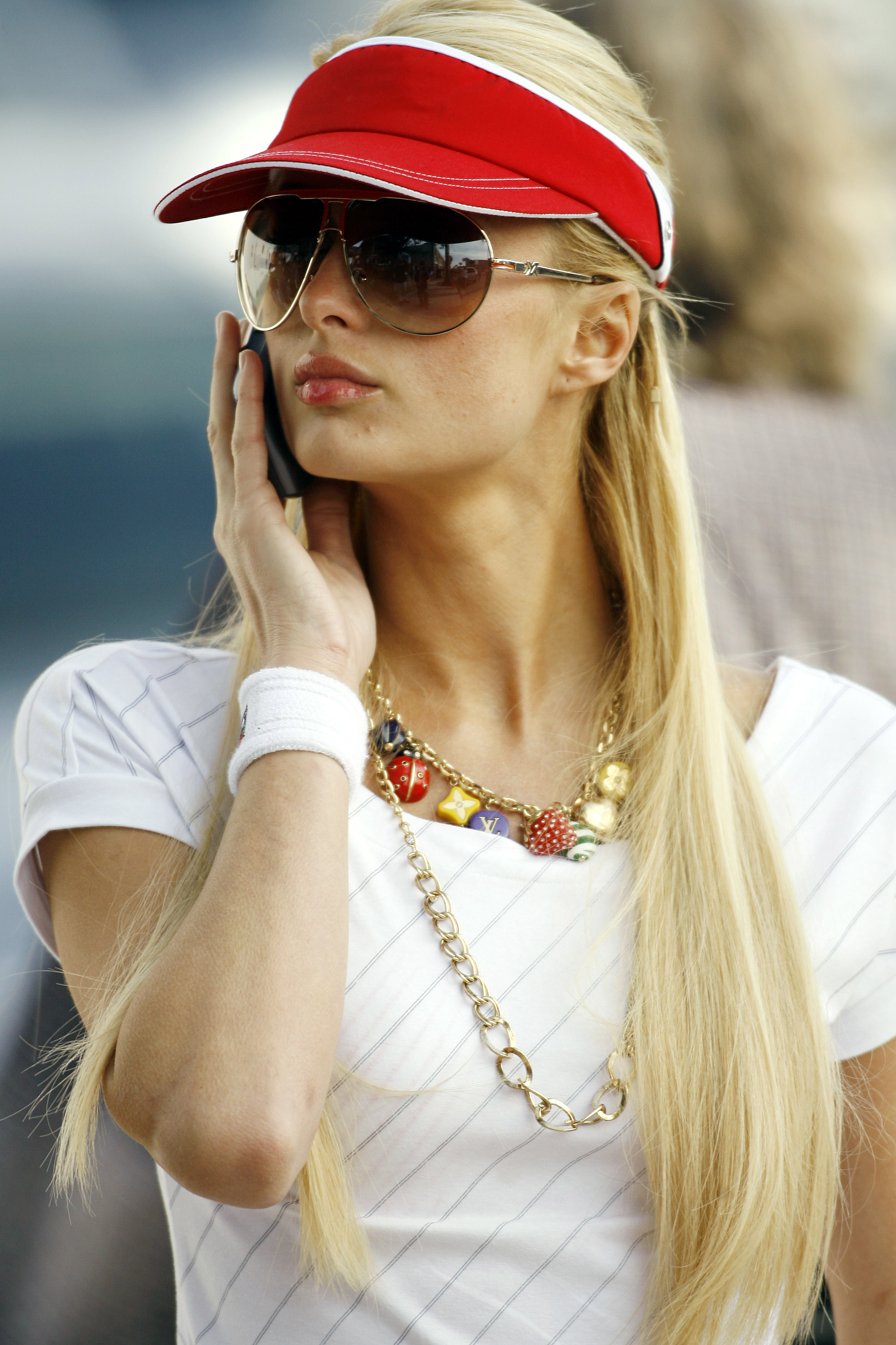 Paris Hilton styles a charm necklace