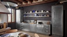 A one-wall stainless steel kitchen with retro-style units and wood accents