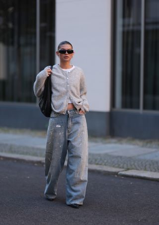 Woman wearing t-shirt, cardigan and jeans