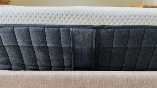 A close up of the side of the Emma NextGen Cooling Mattress, including the handles and the removable cover