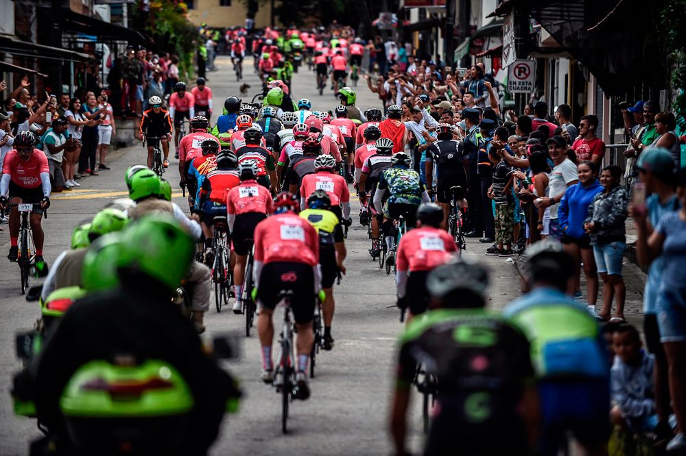 Pro and amateur cyclist ride the peloton during the Giro de Rigo