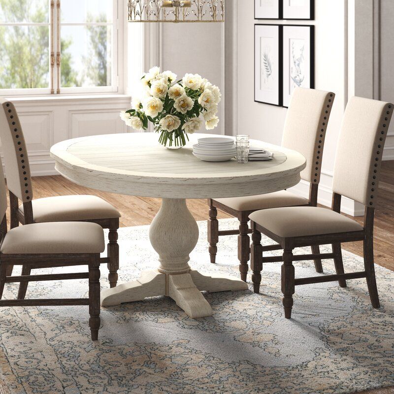 A white oval-shaped dining table that