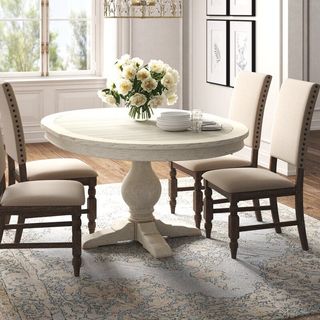 A white oval-shaped dining table that's a part of Kelly Clarkson's furniture collection.