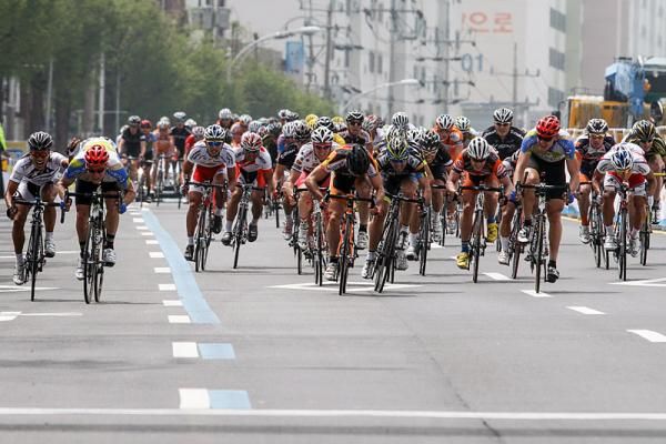 In the sprint to the line Chan Jae Jang (Terengganu Cycling Team), left, raises an arm in protest about Alexander Serebrayakov (Team Type 1 - Sanofi)
