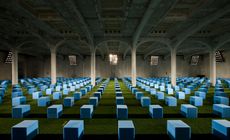 Prada S/S 2012 menswear: AMO created a seating configuration comprising a 'field' of 600 cornflower blue foam blocks spread out on top of bright green artificial grass