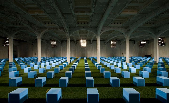 Prada S/S 2012 menswear: AMO created a seating configuration comprising a &#039;field&#039; of 600 cornflower blue foam blocks spread out on top of bright green artificial grass