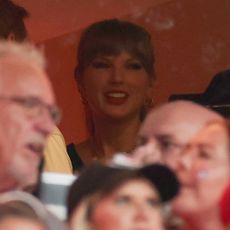 Taylor Swift in the stands at the Chiefs game wearing a custom jersey and Louis Vuitton earrings