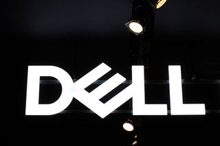 Dell logo, lit in white and shot from below with a telephoto lens on a conference floor