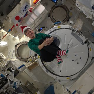 NASA astronaut Peggy Whitson dons a Santa hat and Christmas socks in weightlessness to celebrate the holidays on the International Space Station on Dec. 22, 2016.