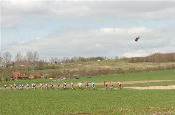 The peloton snakes through the lanes of Flanders