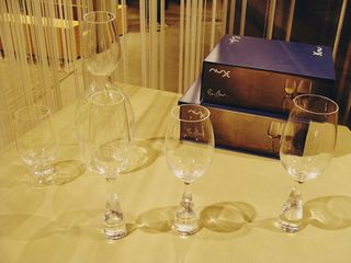 Different sized glasses on a wooden surface.
