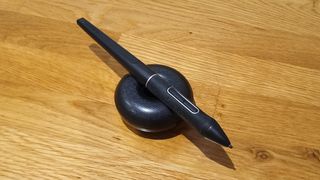 Huion Inspiroy Dial 2 review; a pen stylus on a stand