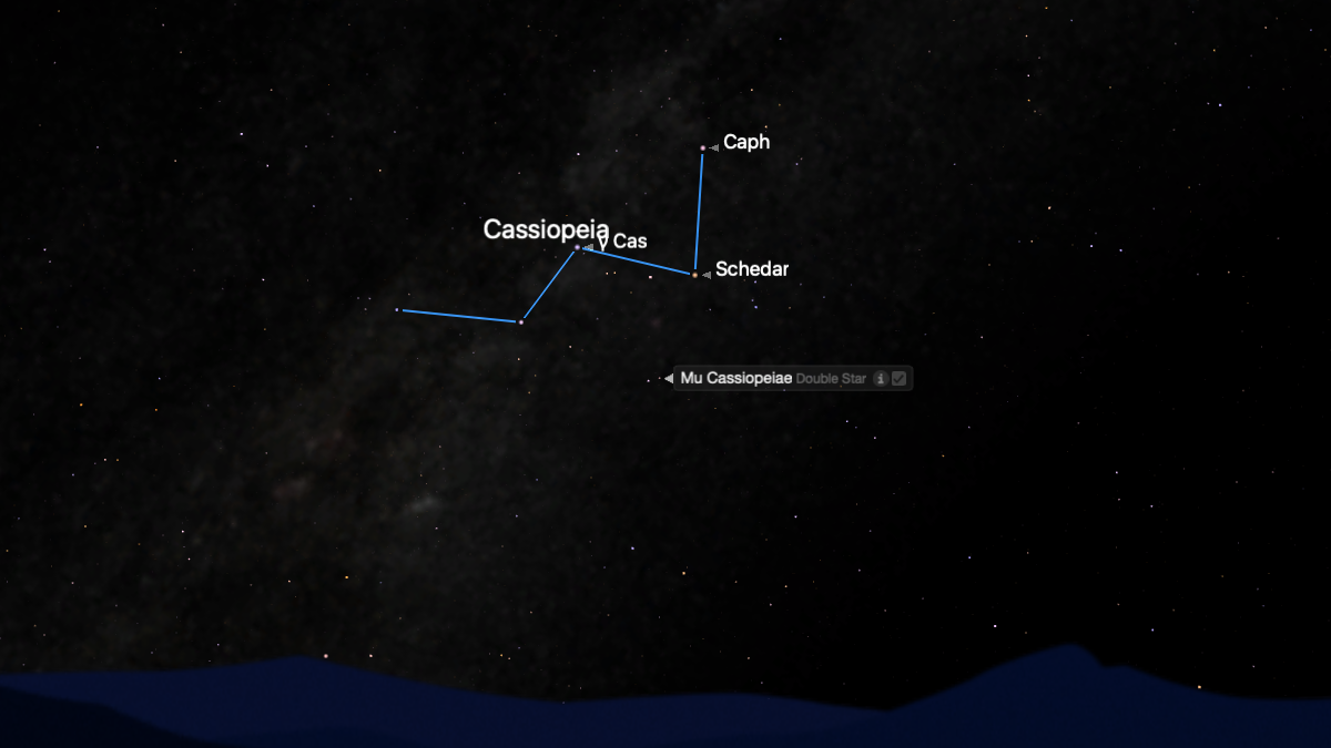 The stars of the constellation Cassiopeia are shown connected by a blue line forming a 'w' shape against a simulated night sky.