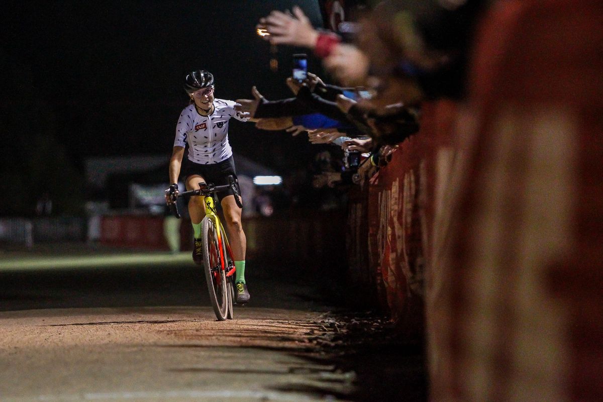 Maghalie Rochette (CX Fever) slaps hands on her way to the finish