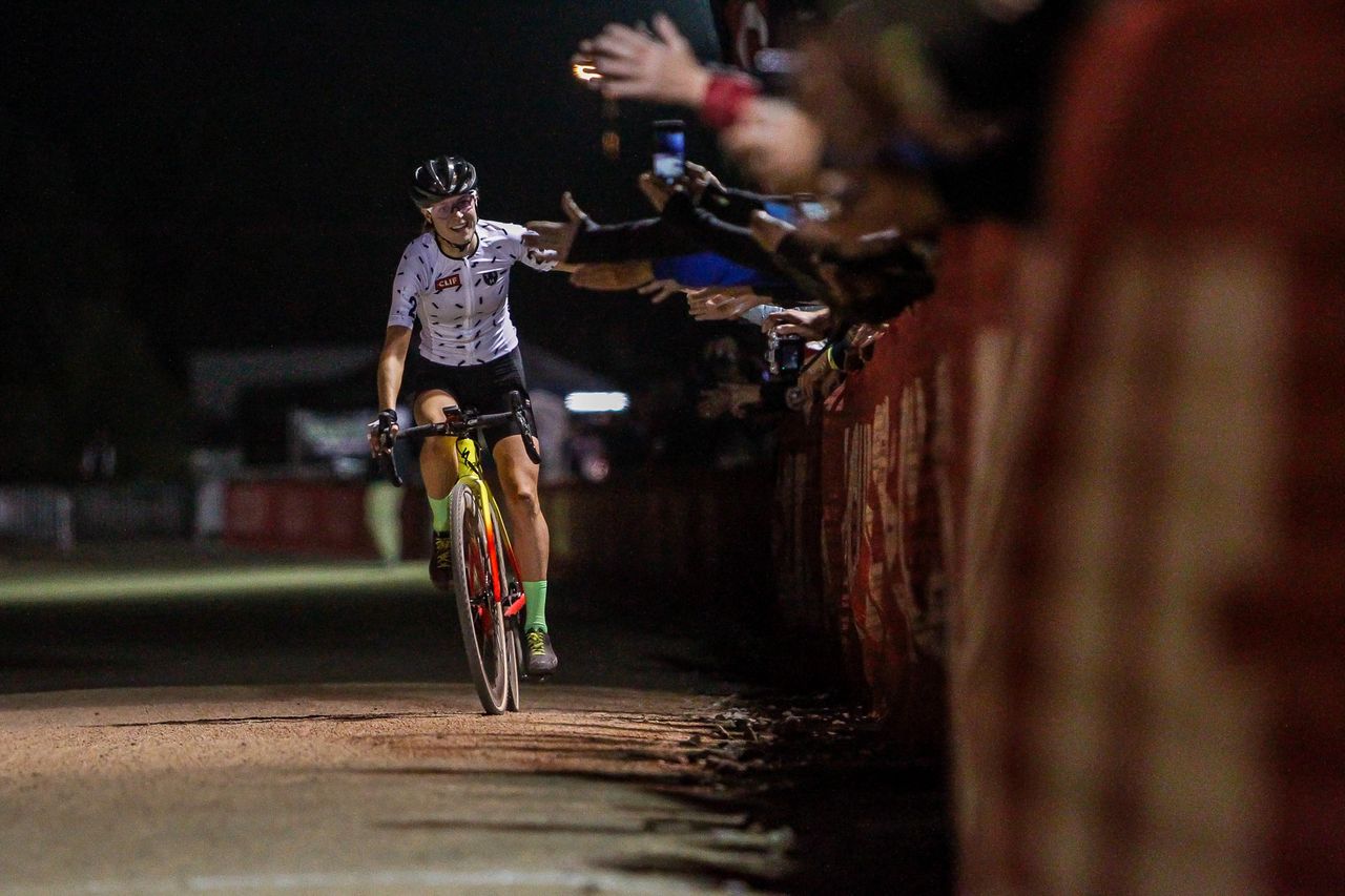 Maghalie Rochette (CX Fever) slaps hands on her way to the finish