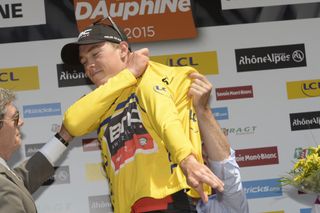 Rohan Dennis pulls on the leader's yellow jersey