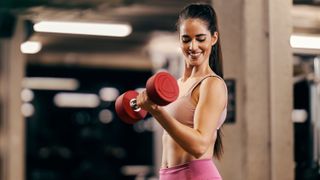 a woman curling a dumbbell