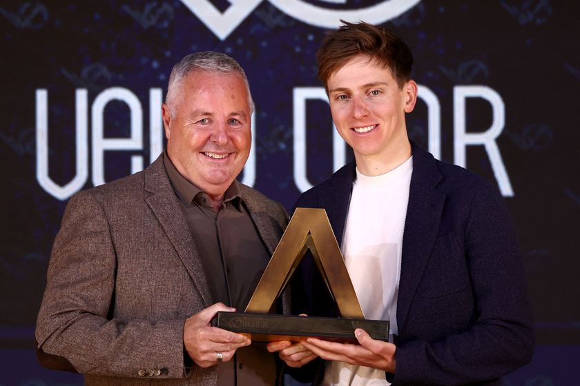 Slovenian rider Tadej Pogacar (R) receives the men&#039;s Velo d&#039;Or trophy from Irish former rider Stephen Roche during the Velo d&#039;Or 2024 award ceremony at the Pavillon Gabriel in Paris on December 6, 2024. (Photo by Anne-Christine POUJOULAT / AFP)