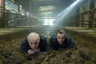 Guilt season 3: Max (Mark Bonnar) and Jake (Jamie Silves) are inside a barn, crawling through a pool of cow dung on their hands and knees
