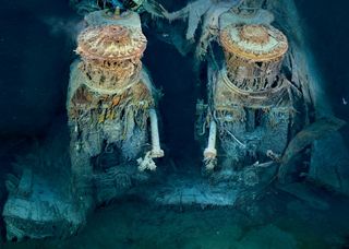 Two of Titanic’s engines lie exposed in a gaping cross section of the stern. Draped in "rusticles"—orange stalactites created by iron-eating bacteria—these massive structures, four stories tall, once powered the largest moving man-made object on Earth.
