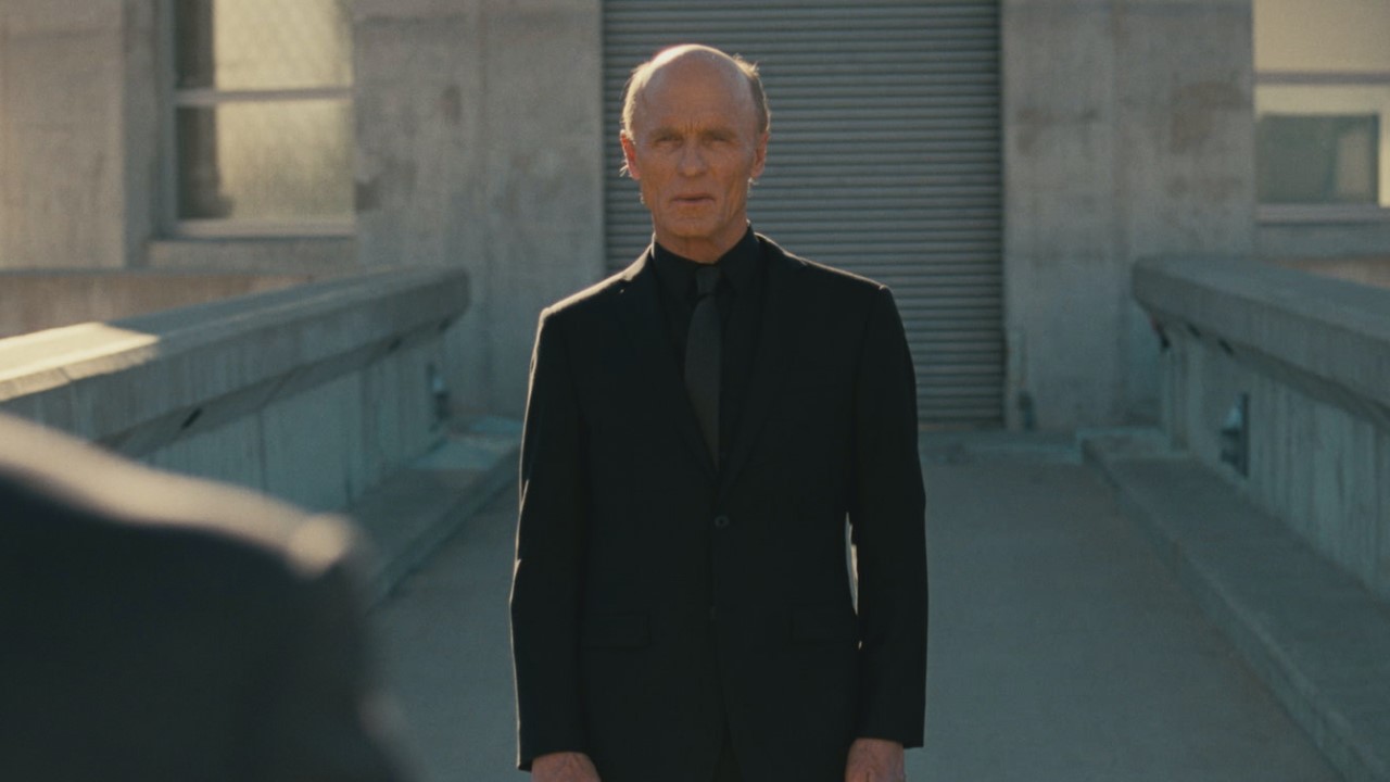 A man in black stands at Hoover Dam in Westworld
