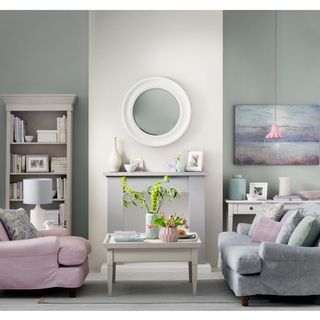 pastel living room with chimney breast wall skimming stone fire surround painted in iron grey and bookcase