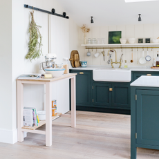 green country-style kitchen with island and butcher's table