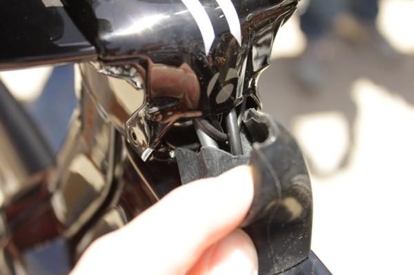 The brake and shifter cables exit the back of the stem into the top tube and are protected by a rubber cover.