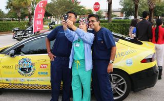 Doctors pause for a selfie with a nurse during the 2014 Drive for Men's Health. For this year's drive, Dr. Jamin Brahmbhatt and Dr. Sijo Parekattil, co-directors of the PUR Clinic in Clermont, Fl., will drive an all-electric Tesla more than 6,000 miles from Florida to New York to California to raise awareness about men's health.