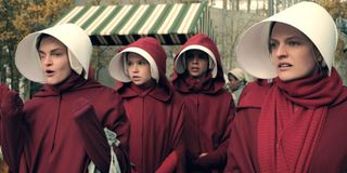 Some of the cast of The Handmaid's Tale in their iconic outfits.