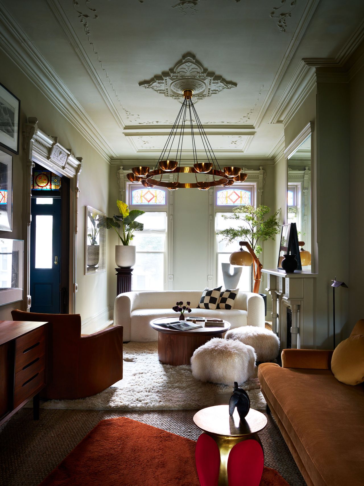 The view through to the front of the living room in a Brownstone house looking through the electic decor mix