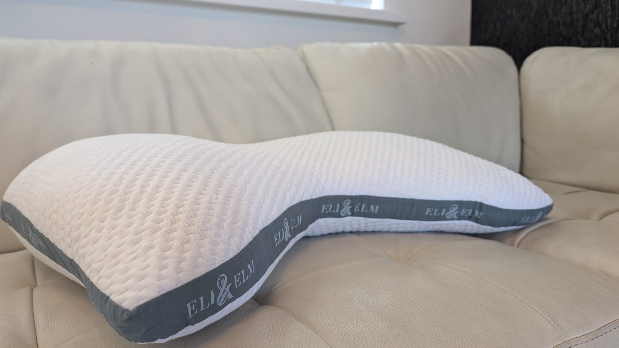 Eli and Elm Side Sleeper Pillow placed on a white couch