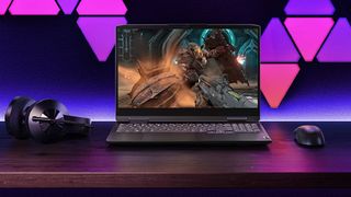 Lenovo Gaming laptop next to gaming headset and gaming mouse