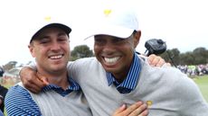 Justin Thomas and Tiger Woods celebrate after winning a match at the 2019 Presidents Cup