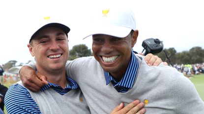 Justin Thomas and Tiger Woods celebrate after winning a match at the 2019 Presidents Cup