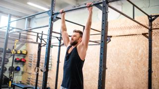 Man training on the horizontal bar at the gym