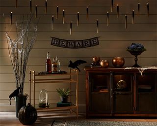 DIY Halloween decorations using battery-operated candles to create a floating candle effect in living room