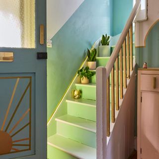 Colourful hallway with green and pink painted staircase