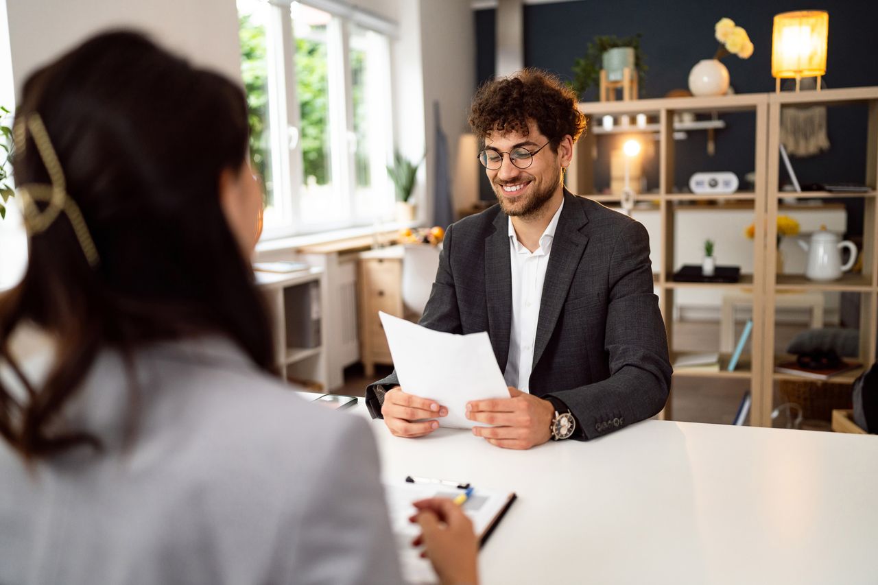 Young male candidate having an interview with a female recruiter/HR at the office