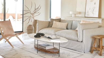 living room in neutral colors with large sofa and coffee table