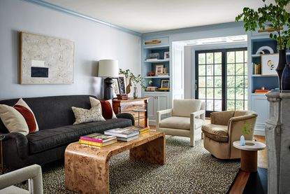 living room with white walls and blue sofa