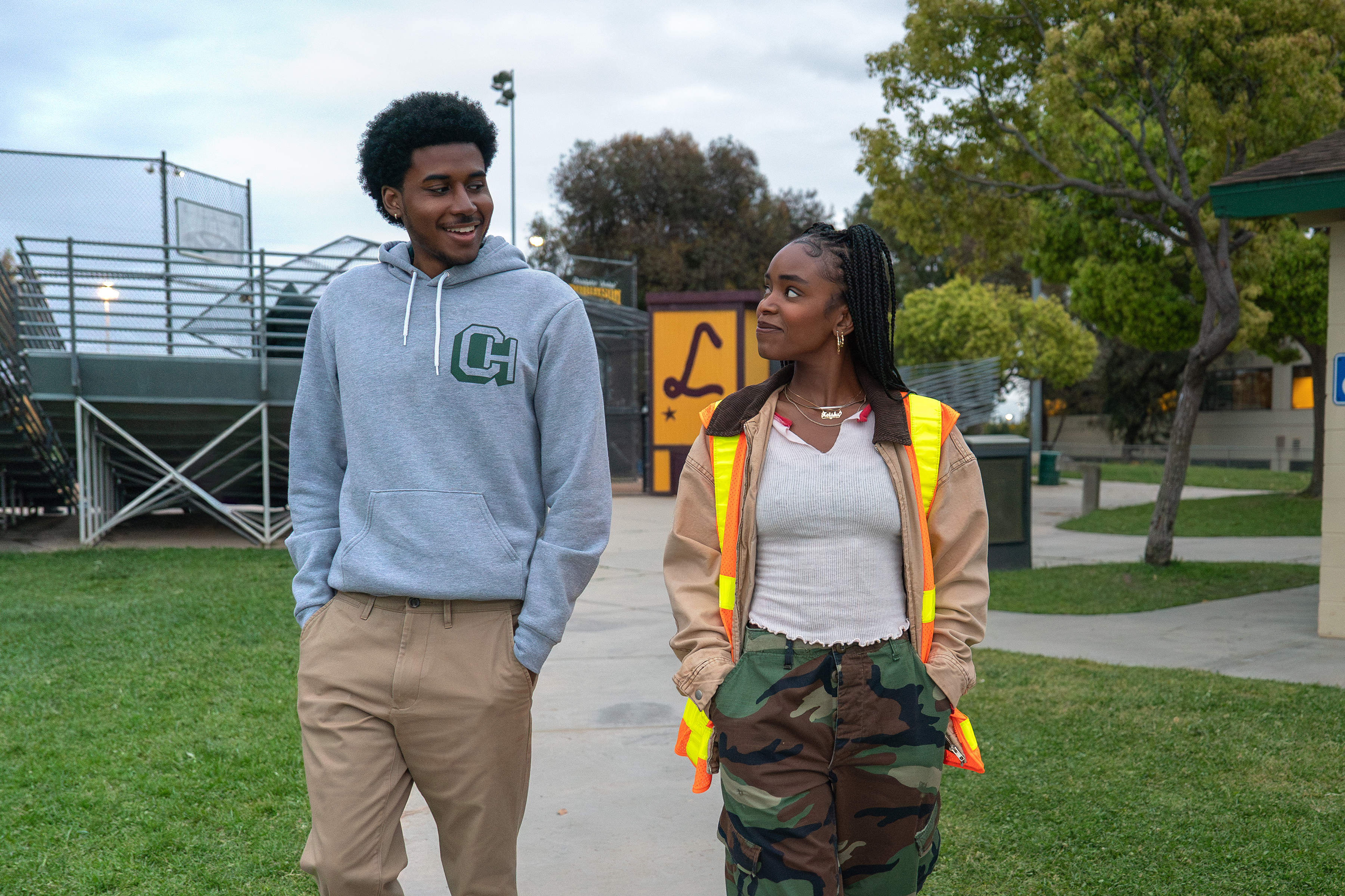 Michael Cooper Jr. as Justin Edwards and Lovie Simone as Keisha Clark, walking through a park, in Episode 103 of Forever.