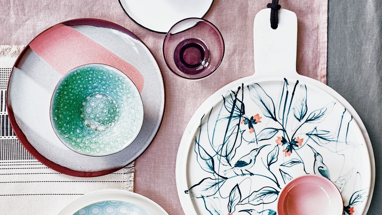 Overhead shot of mismatches plates, bowls and glasses