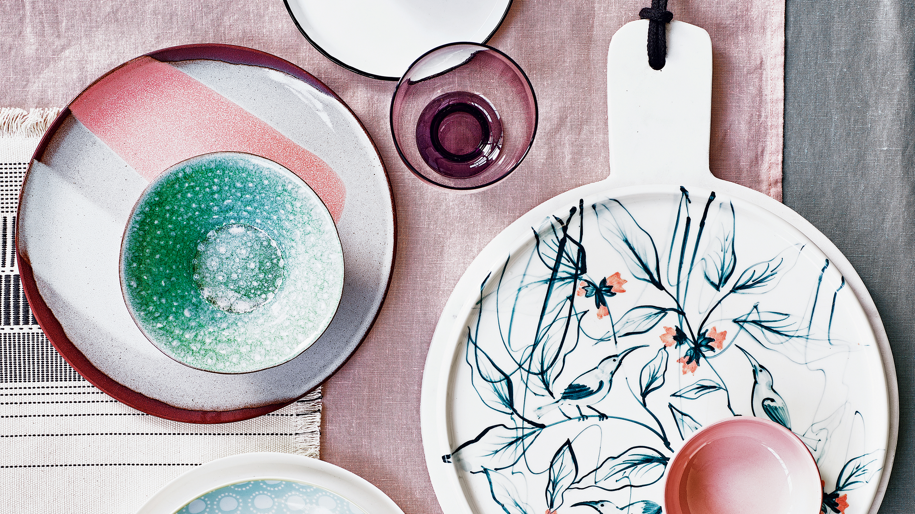 Overhead shot of mismatches plates, bowls and glasses