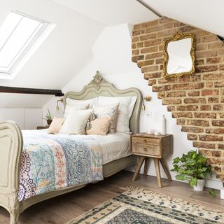 attic bedroom with exposed brick wall
